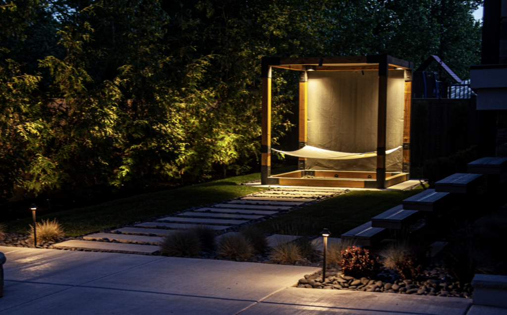 Outdoor living space lit with downlighting and path lighting
